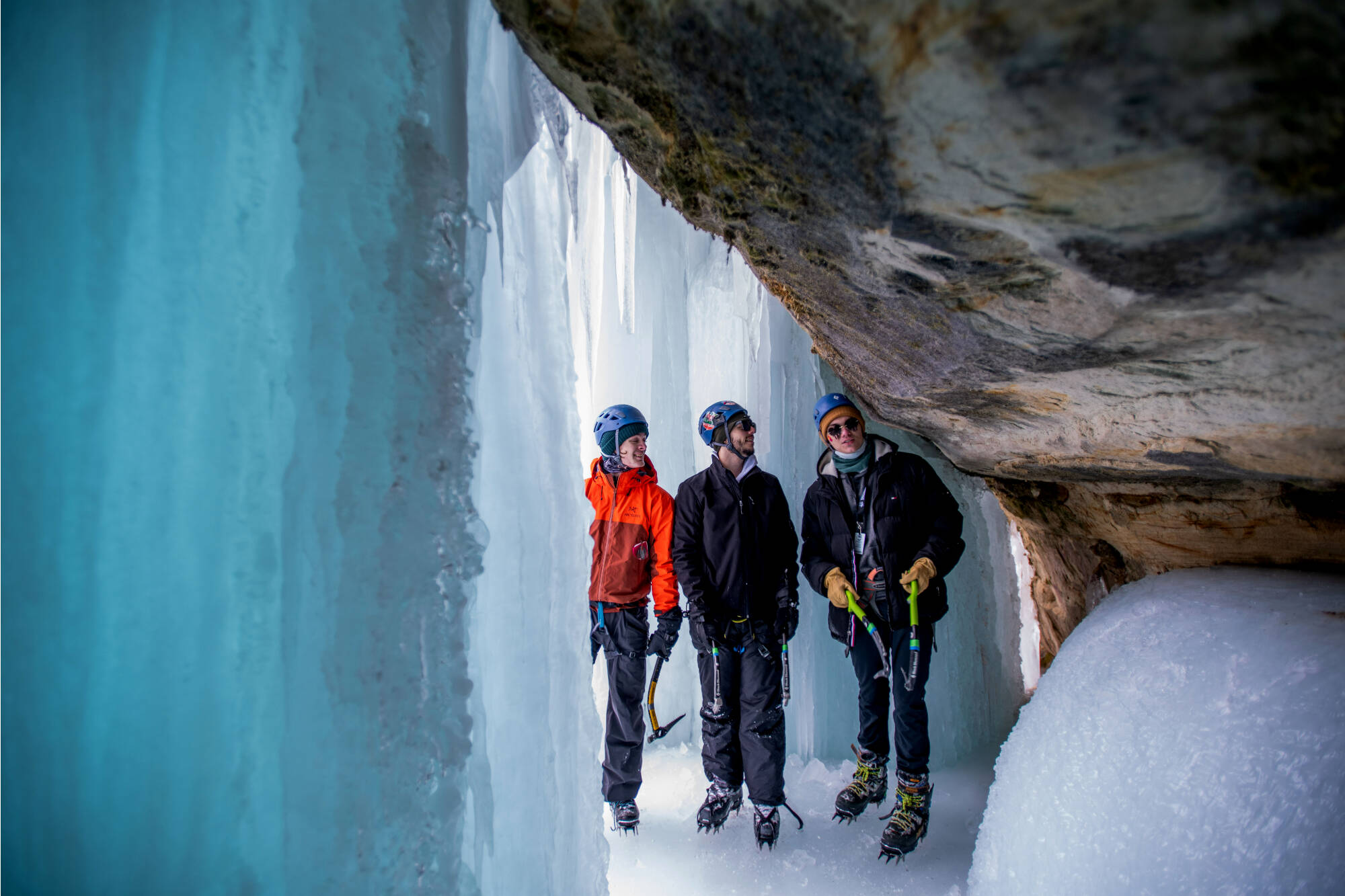 From left, Walker Fairbanks, Andy Hardgrave and Jayden McWhirter explore the ice caves behind The Curtains while waiting their turn to climb.